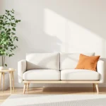 Warm minimalist small apartment living room with a linen sofa, light oak table, and neutral rug.